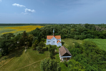 Obraz premium The Szapary Chapel in Tiszabura, Hungary is a neo-Gothic style building constructed by the Szapary family, featuring pointed arch windows and an ornate facade.