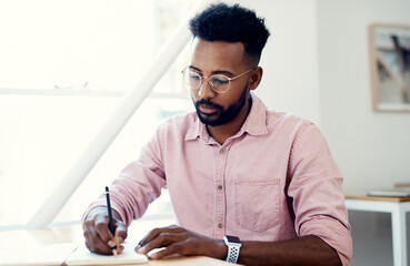 Creative, black man and writing on book in office with notes of schedule, reminder and agenda for...