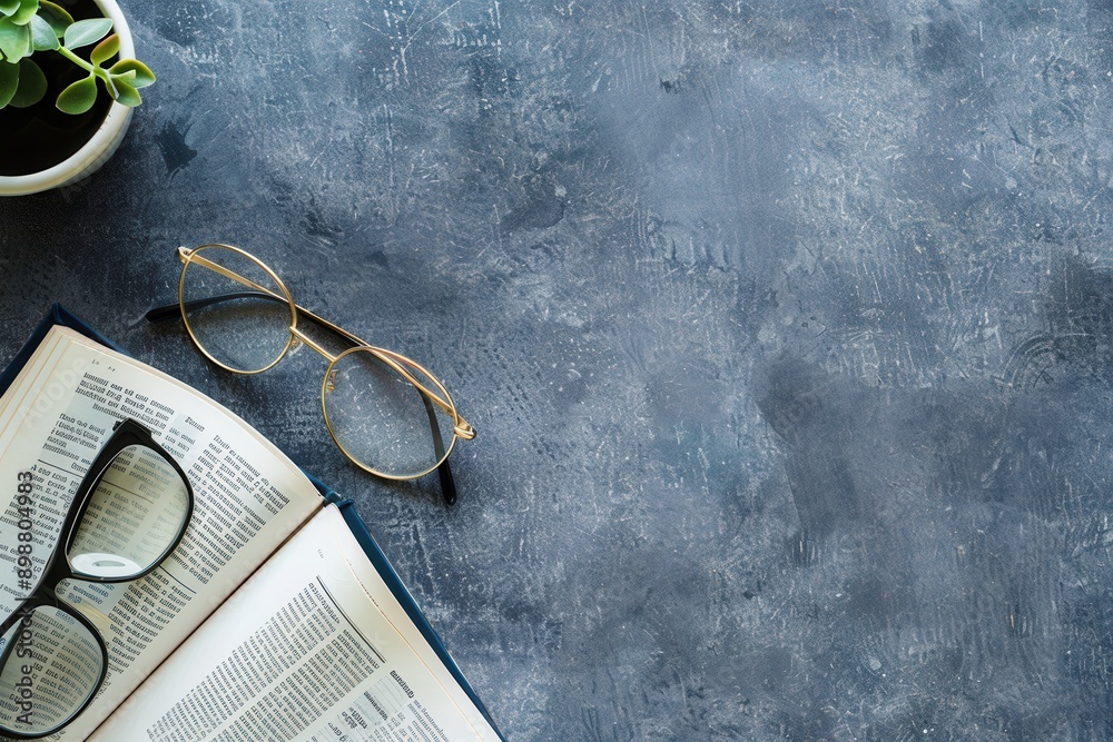 Aufkleber a book lies open on a grey concrete surface, with a pair of eyeglasses resting on the page. generati