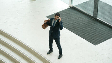 Professional business man talking to skilled executive manager while standing at door. Top view of manager calling colleague by using phone.while discussing about project plan. Changing job. Exultant.