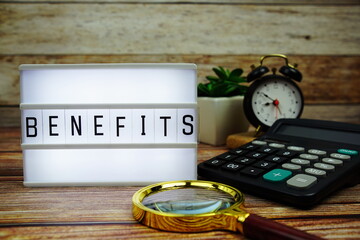 BENEFITS letterboard text on LED Lightbox on wooden background, Business and Finance concept background