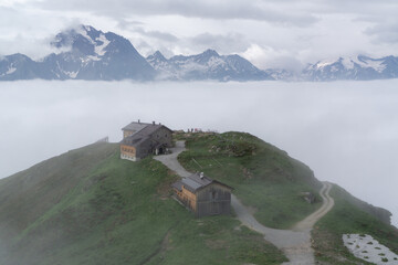 alpine hut on a mountain above the clouds