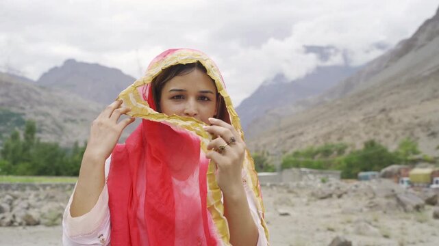 A Pakistani woman tourist travel in Karakoram high mountain hills. Nature landscape background, Skardu-Gilgit, Pakistan. Travel on holiday vacation. People lifestyle.
