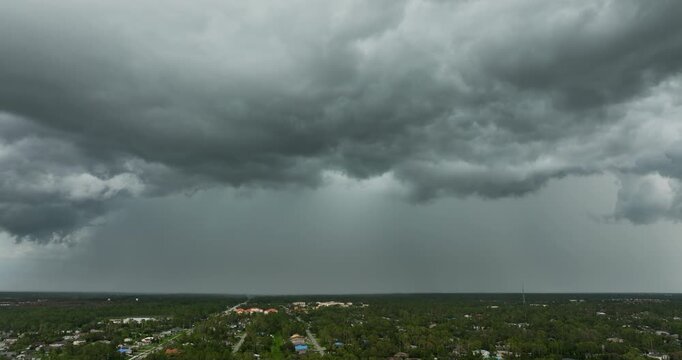 Stormy clouds forming during thunderstorm on dark sky. Moving and changing cloudscape weather