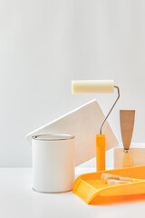 Geometric podium or pedestal with paint can, brush, sponge roller on a white background. Mock up...