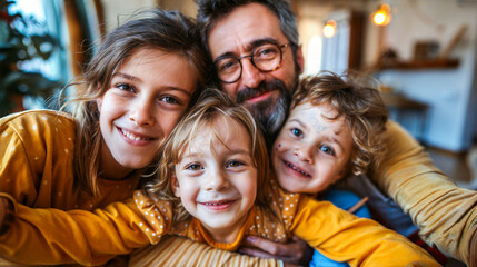 Fototapeta premium A father with his three children, two girls and a boy, smiling a