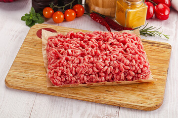 Raw minced beef meat over board