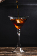coffee stream going into iced coffee on a cocktail glass