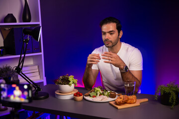Healthy influencer in host channel presenting fresh vegetables in special dish of salad with brest...