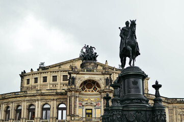 The majestic statue of King Johann in the center of the square against the background of the architecture of the opera house in summer in Dresden