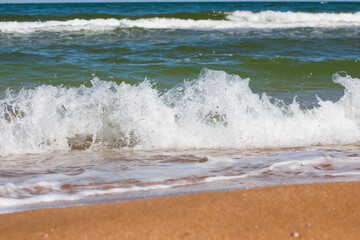 foam waves on a sandy beach. Seascape