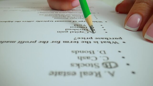 Close up shot of woman at the desk working with important exam document, student reading and picking answers in test, circling with pencil letters for questions.
