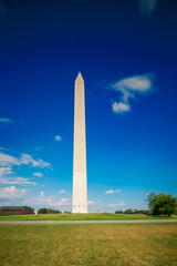 Washington Monument DC, USA, 2024. American Flags. Deep blue sky