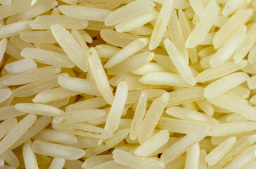 Macrophotograph of numerous basmati rice grains seen from the top in great detail.