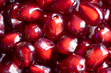 Macrophotography of several red pomegranate berries seen from the top