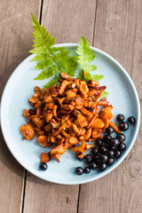 Fried chanterelle mushrooms on a plate. Serving a dish with decor