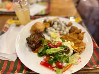 Salad with meat and vegetables on a white plate in a restaurant