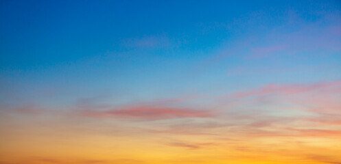 Obraz premium Beautiful Vivid sky painted by the sun leaving bright golden shades.Dense clouds in twilight sky in winter evening.Image of cloud sky on evening time.Evening Vivid sky with clouds