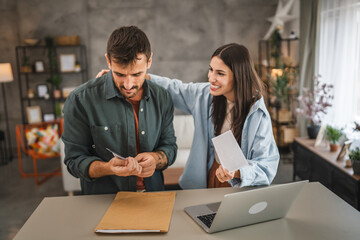 happy couple in love hold ultrasound picture of their first baby
