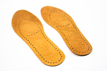 Leather orthopedic shoe insoles. Manufacturing of comfortable insoles for shoes, boots