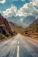 Naklejka premium A serene mountain road with a vast landscape of mountains in the background, ideal for outdoor and adventure scenes