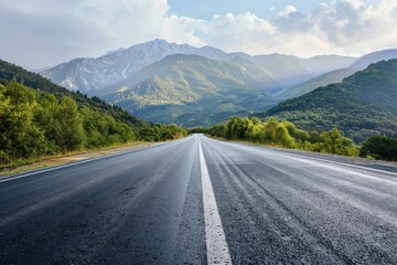 Naklejka premium A lonely road stretching into the distance with mountains rising up in the background