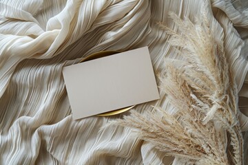 A plain white card sits atop a bed, possibly left as a note or message