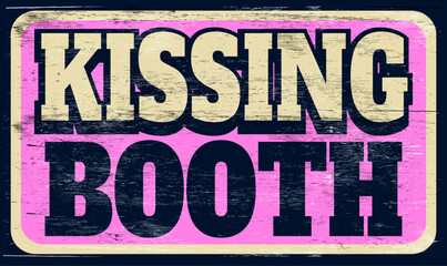 Aged vintage kissing booth sign on wood