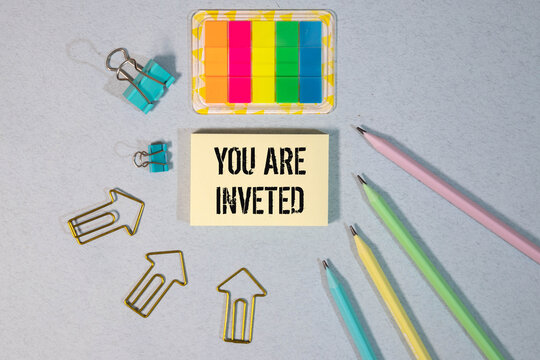paper with text YOU ARE INVETED. Business concept