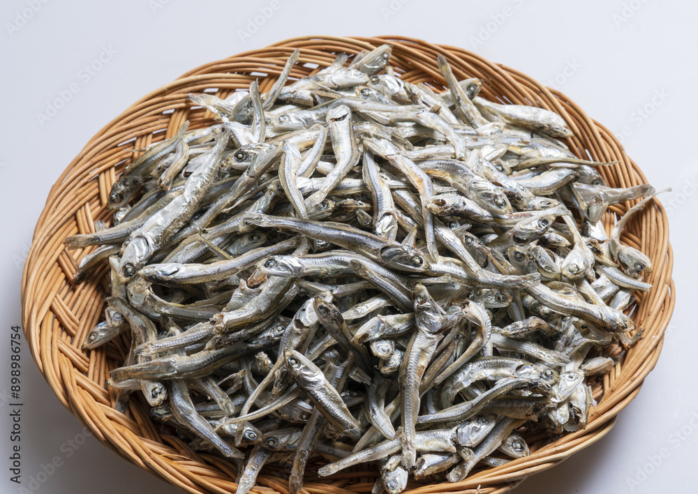 Poster Close-up of stacked boiled and dried anchovy on bamboo basket, South Korea
