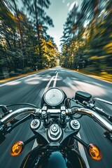 Naklejka premium A motorcyclist riding on a winding country road surrounded by lush green trees