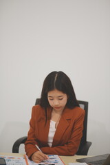 A driven and dedicated young professional showcases her efficiency and attention to detail as she works diligently on her laptop