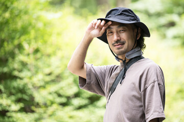 Man enjoying the summer outdoors, looking at the camera