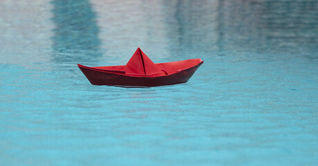 Paper boat sailing. Traveling concept. Summer traveling. Sail boat. Summertime vacation. Paper ship and ocean water. Paper boat in water. Tourism and traveling, travel dreams vacation holiday,