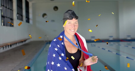 Image of confetti over caucasian female swimmer with medal and flag of usa