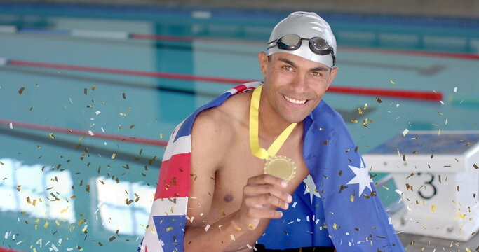 Image of confetti over biracial male swimmer holding medal with flag of australia