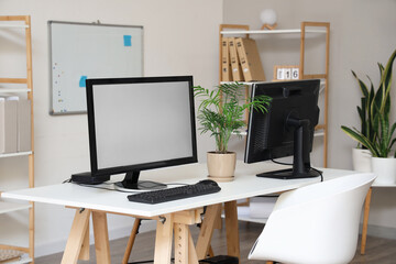 Modern workplace with computer monitors in office