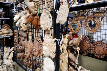 Various handmade wooden statues and carvings at Sukawati Art Market, showcasing intricate craftsmanship and traditional Balinese designs. Culture, art, travel, and souvenirs for tourist