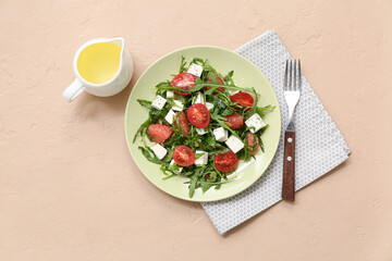Plate of fresh vegetable salad with napkin and fork on beige background