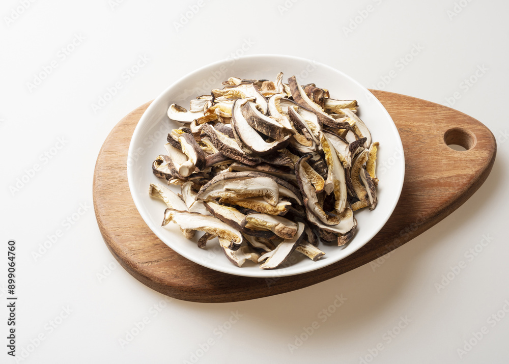 Poster Close-up of dried shiitake mushrooms on dish and wood cutting board, South Korea
