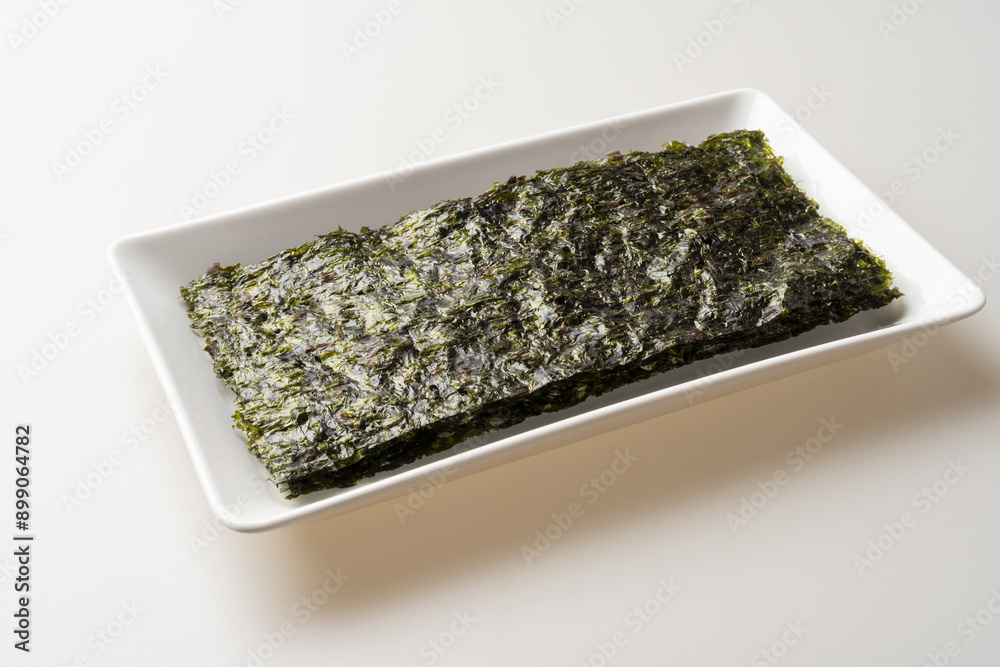 Sticker Close-up and top angle view of dried seaweed pieces on rectangular dish, South Korea
