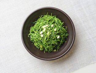 Close-up and top angle view of Seasoned Seaside green(Spergularia marina) on a jar and cloth, South Korea
