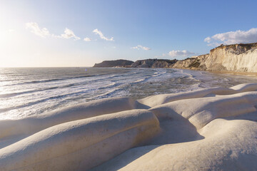 View of white rock cliff Stairs of the Turks or Scala dei Turchi at the mediterranean coast during golden hour at sunset, Realmonte, Sicily, Italy