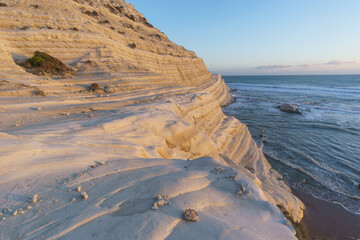 View of white rock cliff Stairs of the Turks or Scala dei Turchi at the mediterranean coast during golden hour at sunset, Realmonte, Sicily, Italy