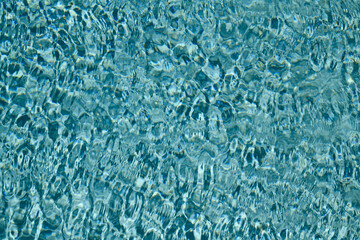 Swimming pool water with copy space. Water surface in swimming pool. Blue water background. Clear sea water texture. Sea ocean background.