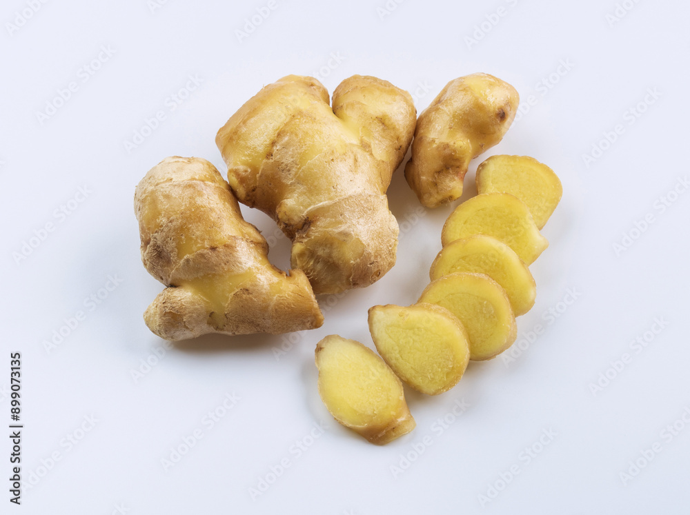 Poster Close-up of fresh ginger root with cut pieces on white floor, South Korea
