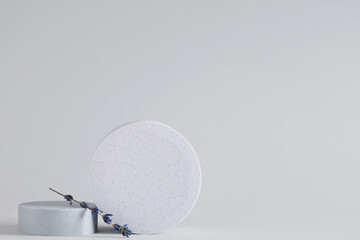 Decorative podiums with lavender flowers on grey background