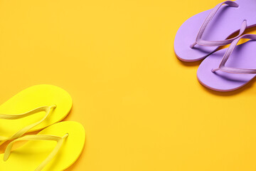 Frame made of beach flip-flops on orange background