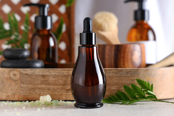 Wooden board with cosmetic products and spa accessories on light table