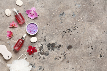 Composition with bottles of essential oil, spa accessories and orchid flowers on grunge background